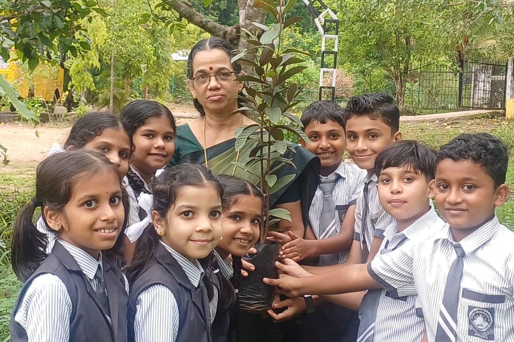 Students planting a sapling